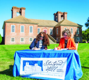 (From left) Brett Glymph, the Executive Director of Virginia Outdoors Foundation and Karen Daly as they sign the conservation easement. (Photo Terry Cosgrove)